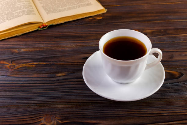 istock Cup of coffee on a wooden table 843800238