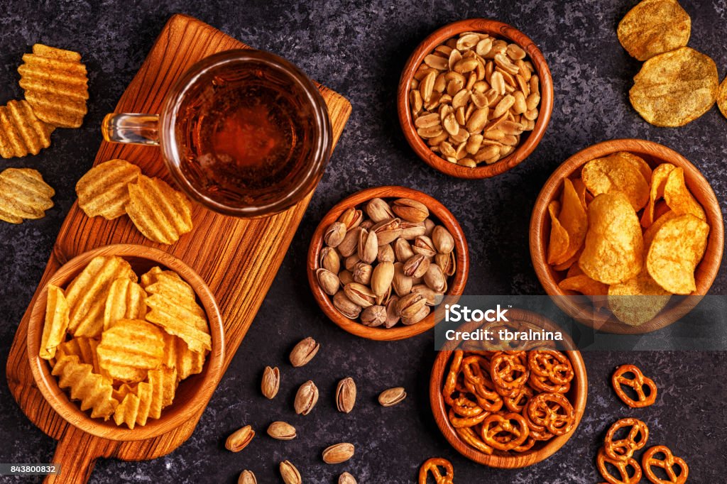Beer with snacks on stone background. Beer with snacks on stone background. Top view, copy space. Snack Stock Photo