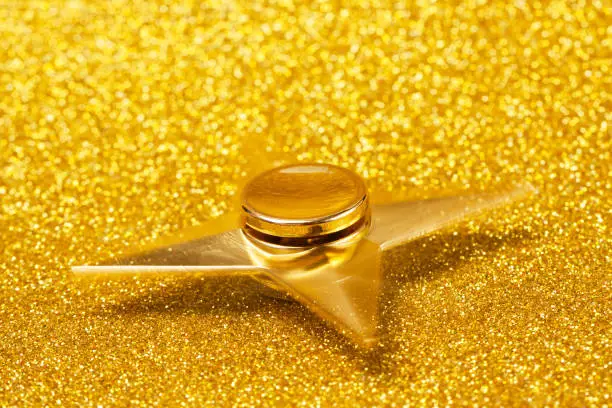 Photo of Golden spinner on a sparkling background