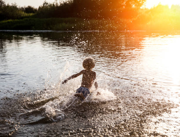 istock kids having fun at lake 843804308