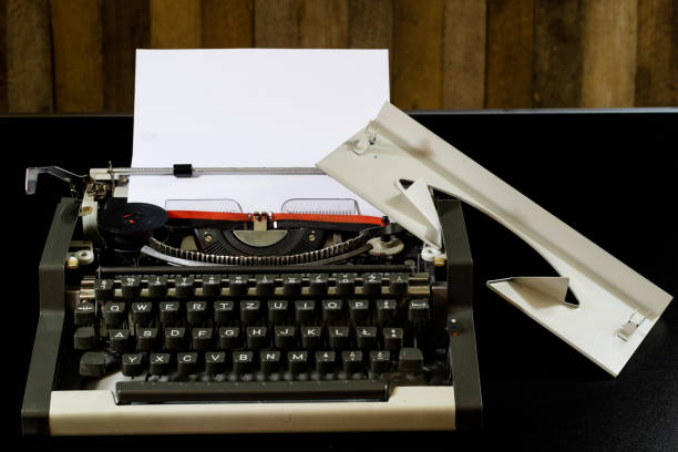 istock typewriter on the black table. White blank card. Wall of rough boards. black background 843807666