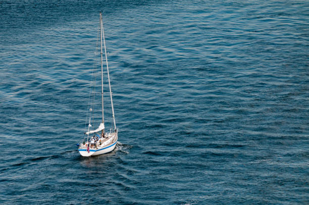 istock Solo sailor and sailboat with sails down 843809840