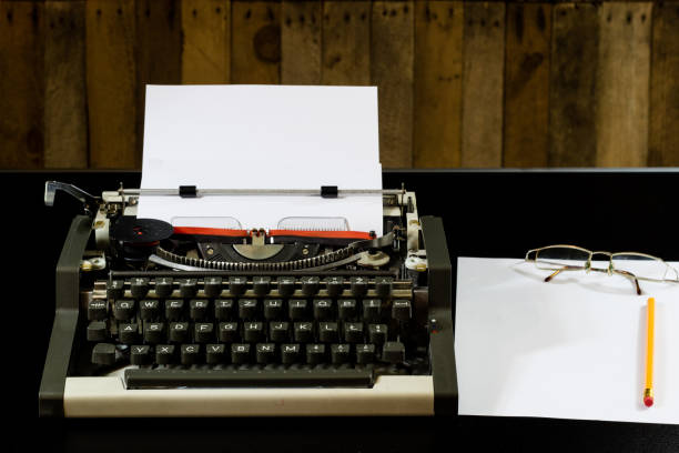 istock typewriter on the black table. White blank card. Wall of rough boards. black background 843810072