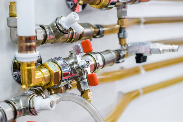 System of plastic pipelines and regulators. Steel curved tubes, brass connectors and valves.