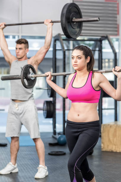 istock Fit couple lifting barbell 843816666