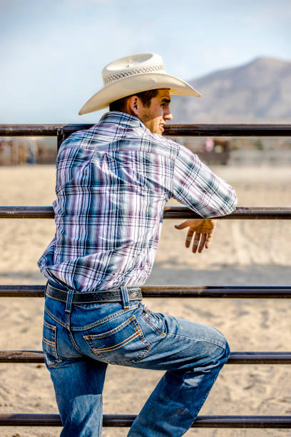 istock Cowboy Leaning on a Fence 843817156