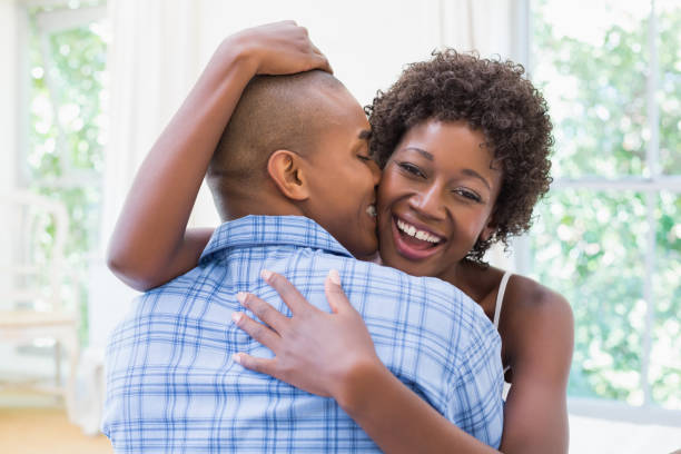 istock Happy couple cuddling on their bed 843817482