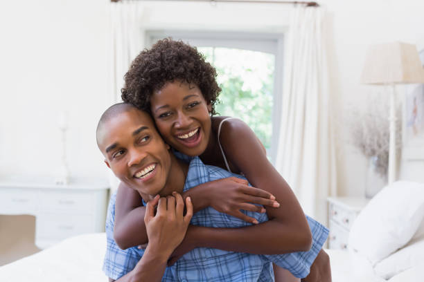 istock Happy couple messing about on their bed 843817514