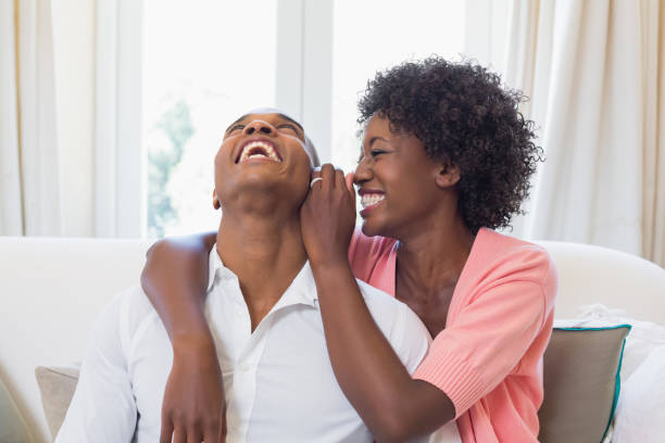 istock Pretty woman telling a secret to partner on couch 843820094