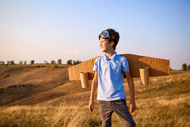 istock Boy child pilot with wings on nature 843833880