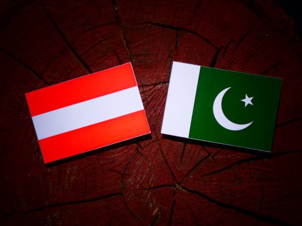 istock Austrian flag with Pakistan flag on a tree stump isolated 843836264