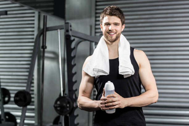 istock Fit man holding water bottle 843847342