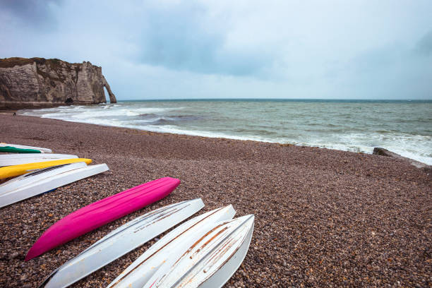 seaside village of Etretat with kayaks on the shore, Normandy, France