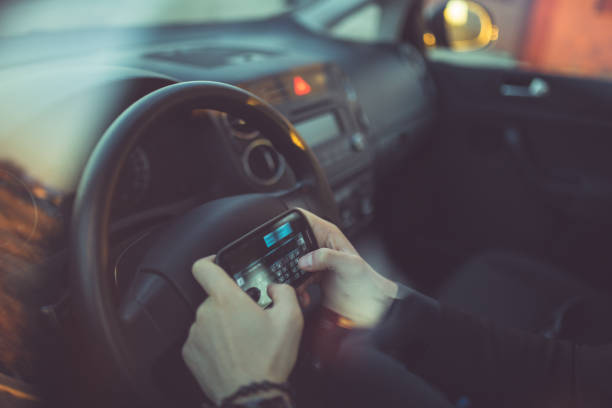 istock Young businessman driving a car and using smartphone 843850868