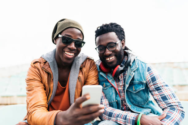 istock Two black race friends having fun with mobile. 843856586