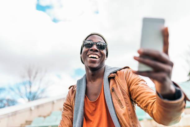 istock American man using mobile in the street. 843857238
