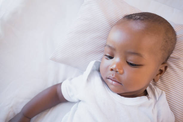 istock Adorable baby boy lying in his crib 843870654