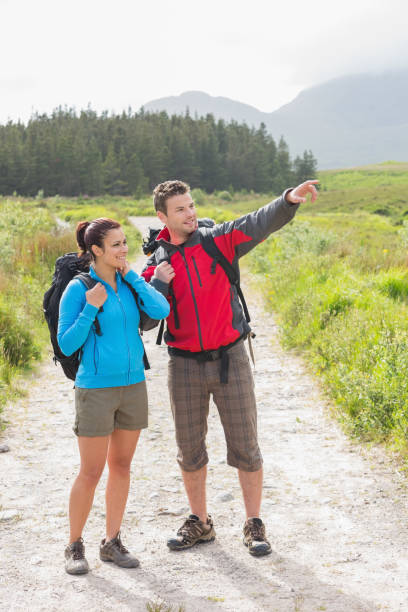 istock Hikers with backpacks standing on country trail 843873452