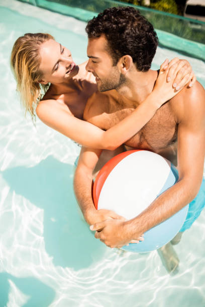 istock Happy couple with beach ball 843878388