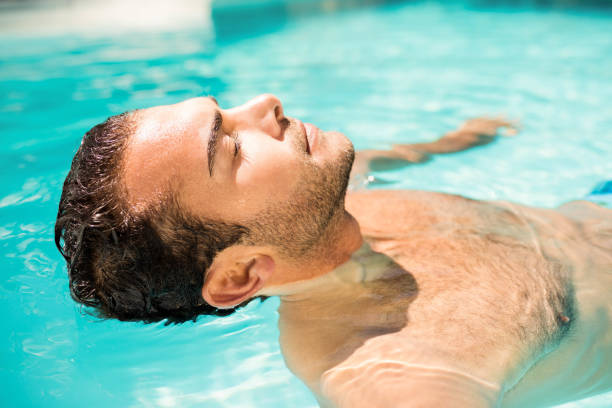 istock Peaceful man floating in the pool 843878474