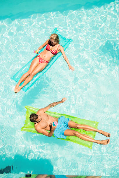 istock Peaceful couple on lilos holding cocktails 843878612