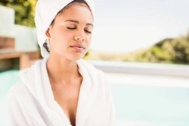 istock Peaceful brunette with closed eyes wearing white towel 843878644