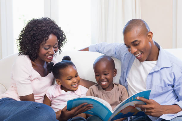 istock Happy family on the couch reading storybook 843888400