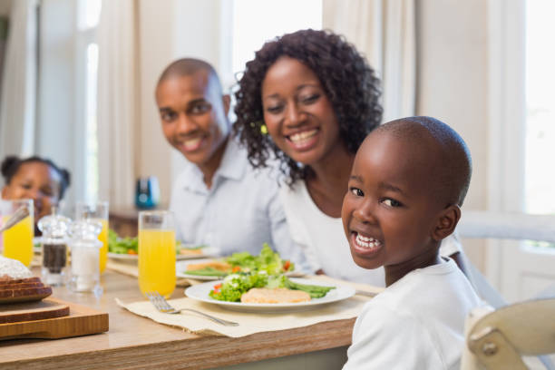 istock Happy family smiling at camera at lunch 843889570