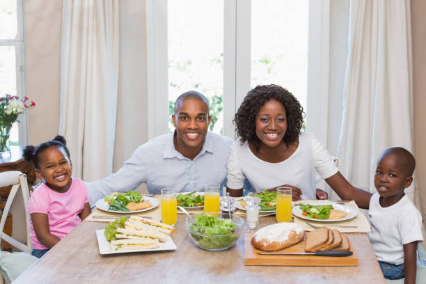 istock Happy family smiling at camera at lunch 843889588