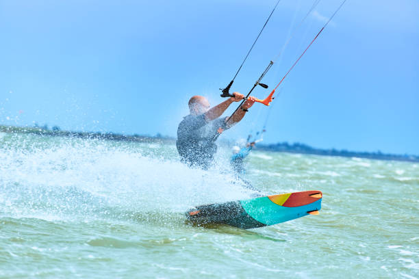 istock Man riding a kite surfing on the waves in the summer. 843889648