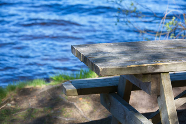 istock Wooden table by the lake 843889806