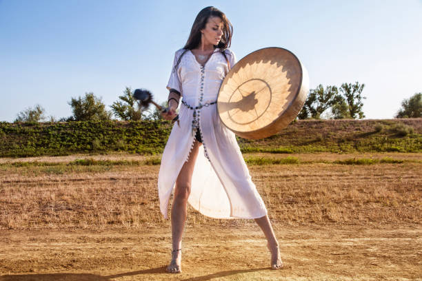 istock Shaman woman  drumming field 843892134