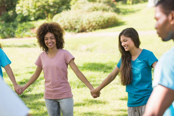 istock Friends holding hands in circle at park 843892480