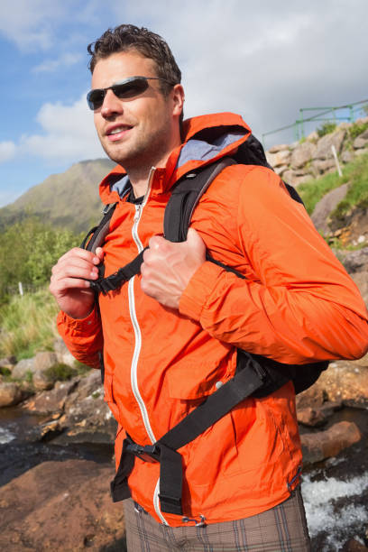 istock Man wearing rain jacket and sunglasses smiling 843892930
