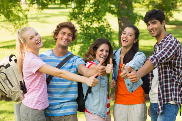 istock College friends gesturing thumbs up in campus 843893068