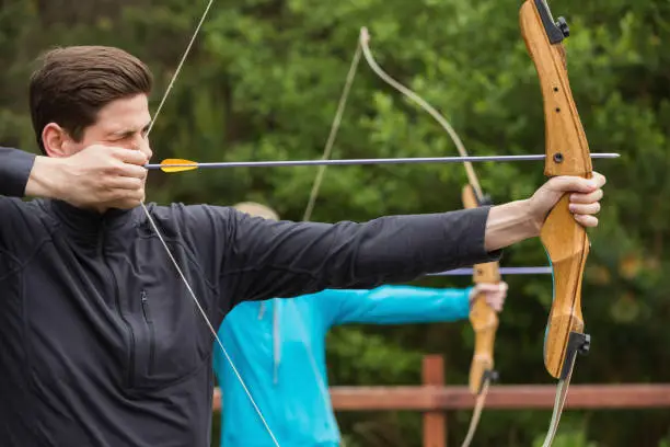 Photo of Handsome man practicing archery