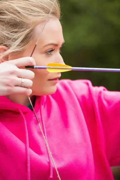 Photo of Focused blonde practicing archery