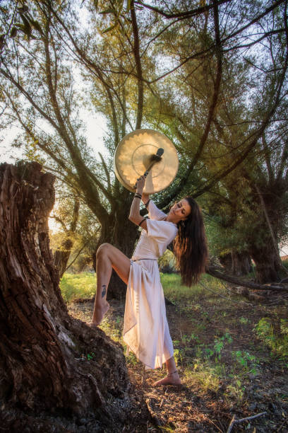 istock Gypsy woman in the forest drumming 843895554