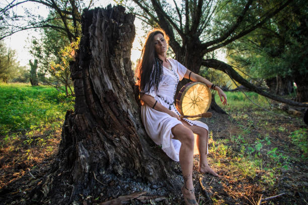 istock Gypsy woman in the forest drumming 843895638