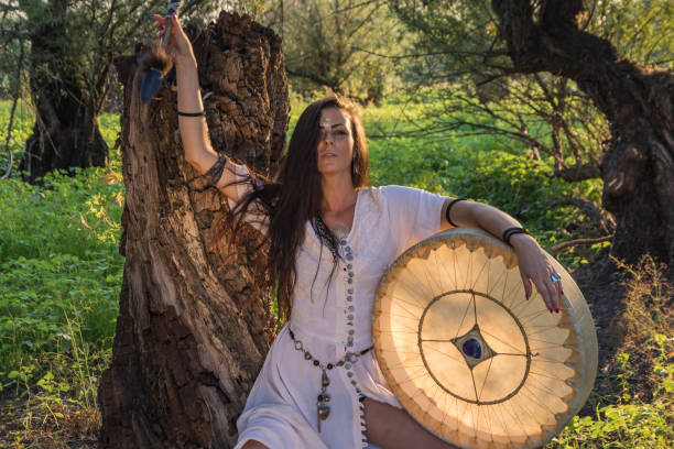 Gypsy woman in the forest drumming