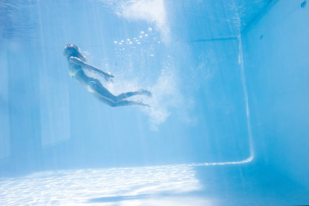 istock Fit woman swimming under water 843896842