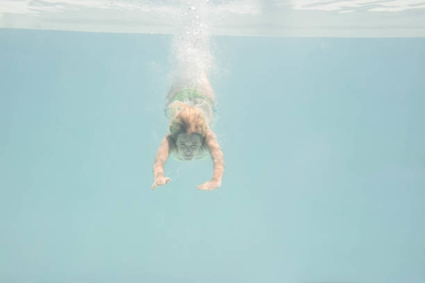 istock Fit woman swimming under water 843896856