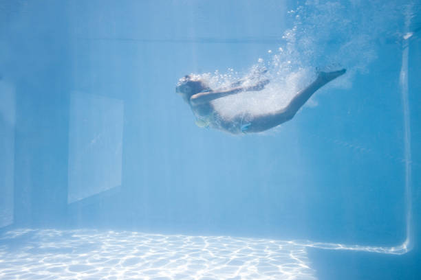 istock Fit woman swimming under water 843899092