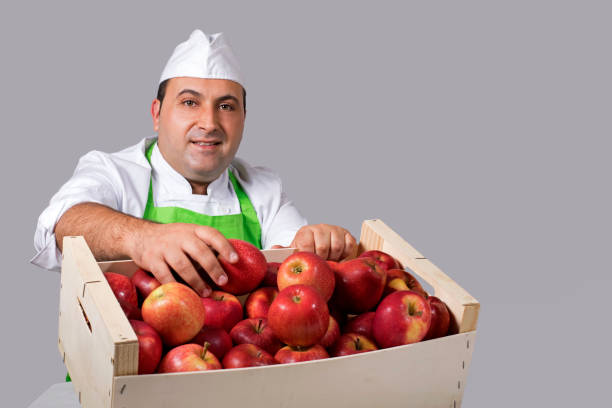 istock Fruit seller with box of apples 843899540