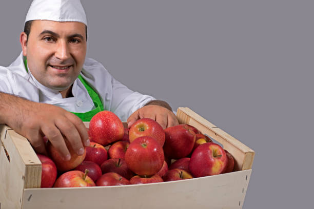 istock Fruit seller with box of apples 843899576