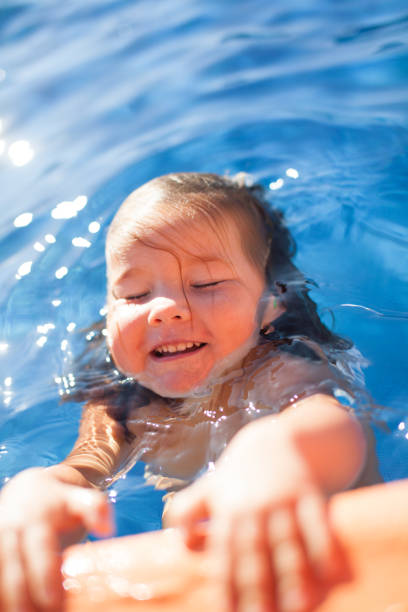 istock happy girl in swimming pool 843902408