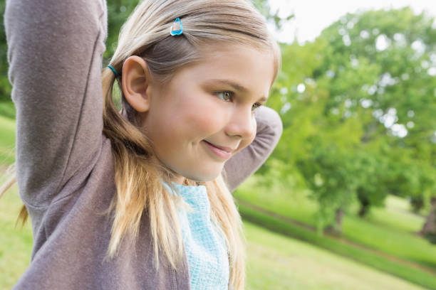 istock Cute smiling young girl at park 843905960