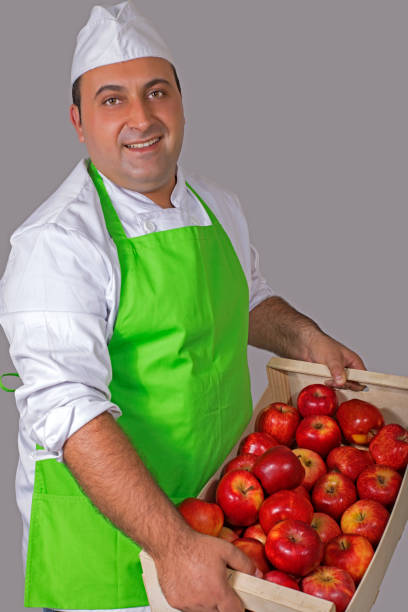 istock Fruit seller with box of apples 843910126