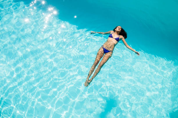 Beautiful woman just about to splash backwards into a pool. Perfect funny face expression. Floating effect. Nikon D3X. Converted from RAW. (XXXL)