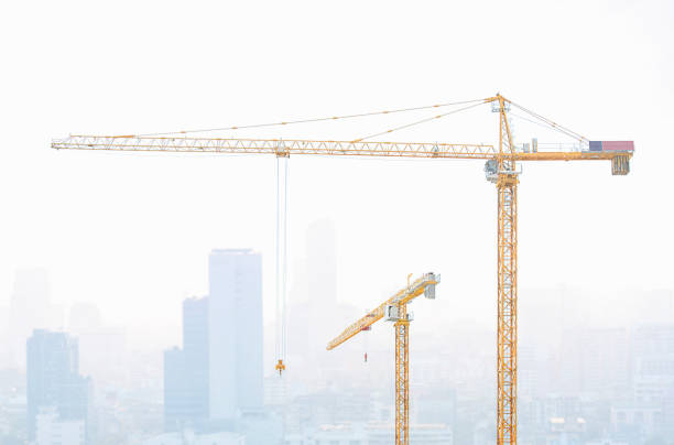 istock High rise construction cranes with city scape. 843914520